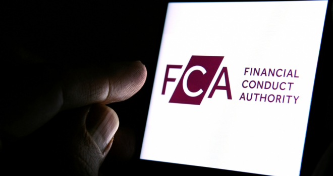 FCA threatens to use regulatory powers if firms fail to comply with Consumer Duty rules glowing FCA logo in the dark with a hand touching it