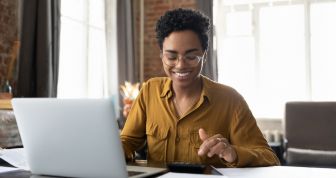 In conversation with Nicola Dryden: women in insurance person at a table using a calculator